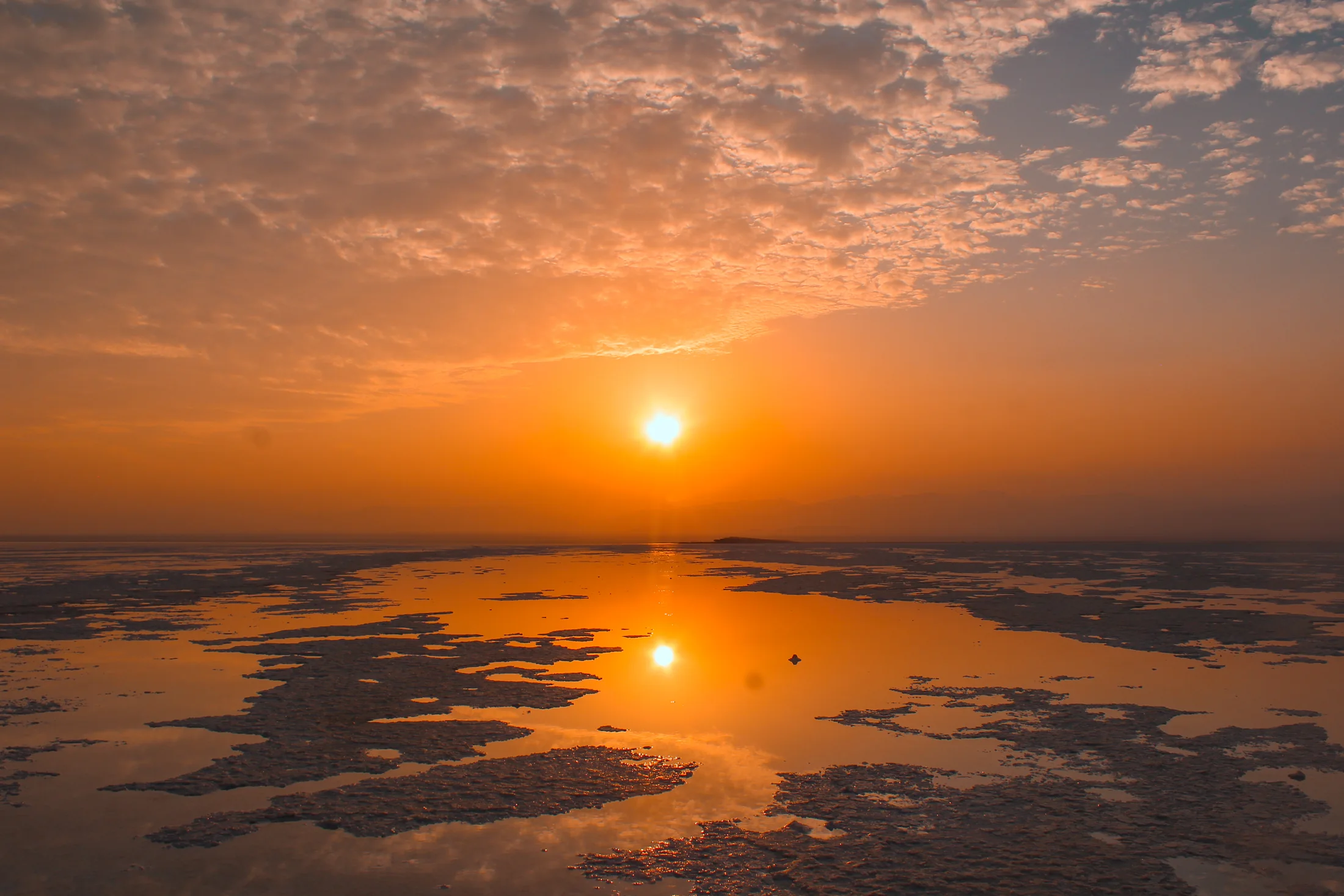 Sunrise reflected across the Danakil landscape